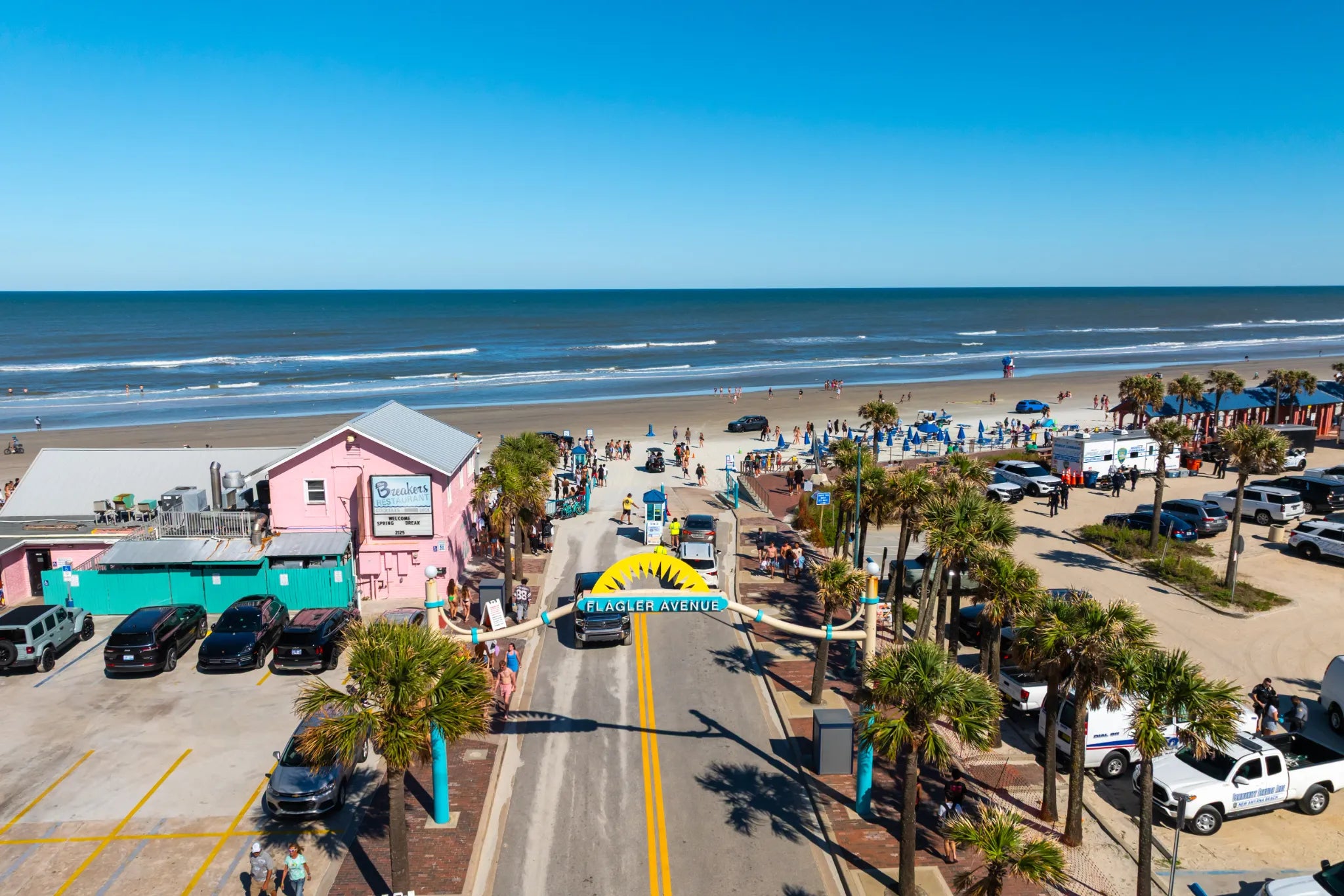 Aerial view of Flagler Avenue, palm trees and the ocean in New Smyrna Beach