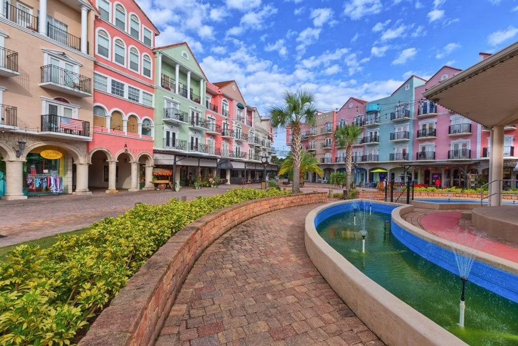 Colorful buildings, palm trees and a courtyard fountain in Palm Coast