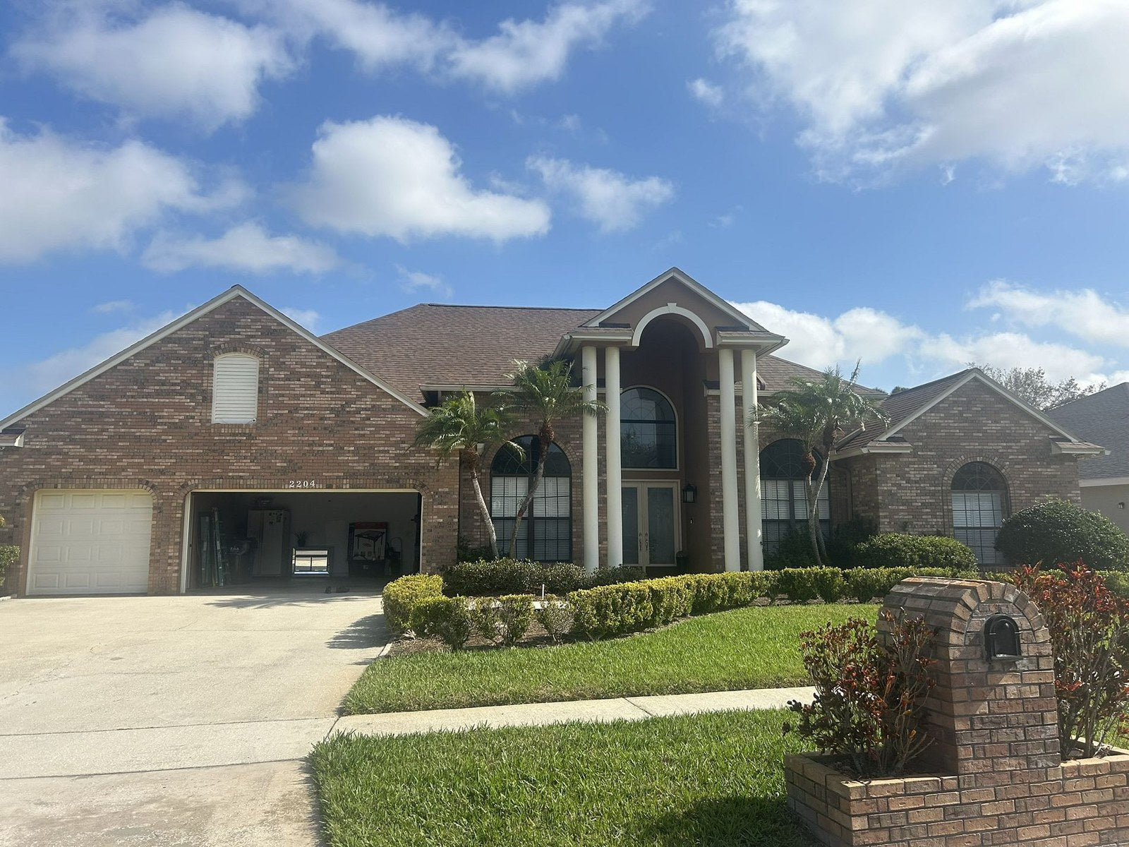 Completed shingle roof on a two-story brick home